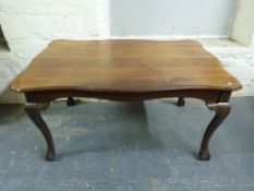 A shaped walnut dining table raised on ball and claw cabriole legs (W150, W98,
