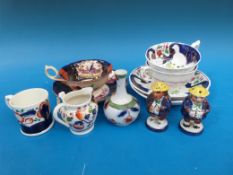 A collection of Gaudy Welsh items including a pair of figural cruets, miniature items,