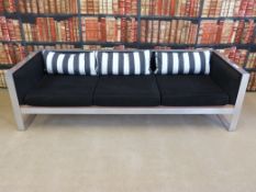 A stainless steel framed three-seater sofa and single armchair,