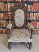 A heavily carved c1900 oak chair with spindle and barley twist frame, decoration to back,