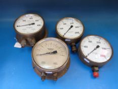 Four various brass cased pressure gauges,