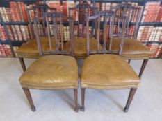 A set of five Georgian style leather upholstered dining chairs