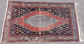 A rug with geometric design on blue ground (200cm x 121cm)