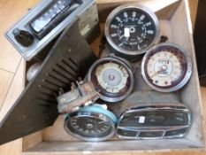 A quantity of circa 1960s/1970s car speedometer and other instruments and a Radiomobile radio