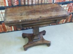 A William IV mahogany card table raised on a tapered stepped column and splayed quatrefoil base