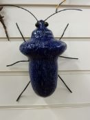 A signed Adrian Holt ceramic exotic insect in a dark blue colourway (25cm)