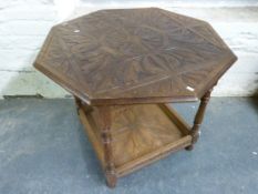 An octagonal carved oak table with shelf below (W91cm)