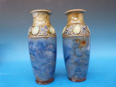 A pair of Royal Doulton vases with relief decoration and inscribed painters' marks to base (20.