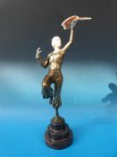A bronze finished Art Deco style figure of a girl with bird,