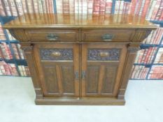 A Victorian carved walnut chiffonier fitted two drawers over cupboards (W128, D46, H106.