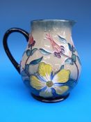 A WM Moorcroft jug decorated with celandines (14cm tall)