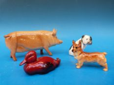 A Royal Doulton Tamworth sow together with a small flambe duck,