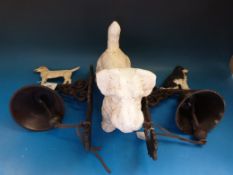 Two cast wall mounted bells with dogs on top and another dog