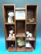 Seven Steiff miniture teddy bears in Steiff wall unit