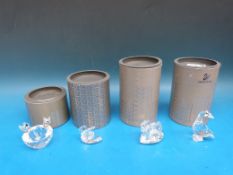 Four Swarovski crystal birds and bird groups, a goose,