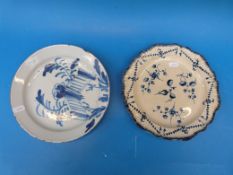 A Delft plate with feather edge and blue decoration of dog rose together with an English Delft dish