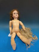 A Simon & Halbig bisque headed doll with open mouth, weighted brown eyes and articulated limbs.