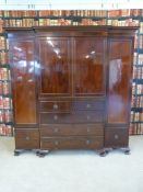 A 19th century mahogany compactum, the centre section having double doors opening to reveal shelves,