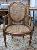 Early 20thC bergere chair with serpentine front and fluted legs