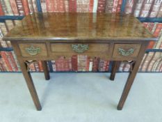 A Georgian oak lowboy, fitted three drawers with shaped frieze and fretwork corners (W81cm, D45cm,