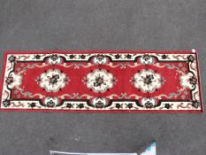 A group of four matching rugs,