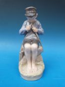 A Copenhagen figure of a boy whittling a stick