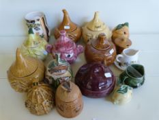 A quantity of assorted condiment servers including face pots