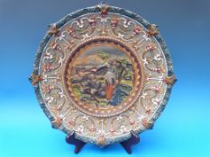 A maiolica charger with figural scene to the centre by William Schiller & Sons,