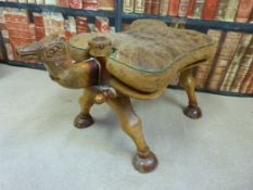 A camel stool with leather seat pad