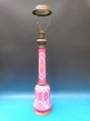 A large pink overlaid cut glass electric lamp decorated with sprays of flowers and brass mounts,