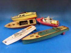 A DW speedboat with clockwork motor with green hull and cream deck together with four other boats,