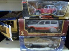 Eleven large scale diecast model vehicles all in original boxes