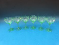 A set of six uranium wine glasses with etched decoration, 12cm tall.