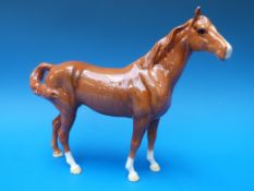 A Beswick chestnut swish tail horse