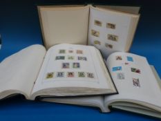 Three Senator albums and a Devo album of foreign stamps