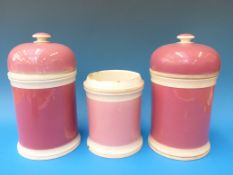 Three apothecary jars on pink ground