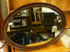 An oval bevelled wall mirror (max diameter 101cm)