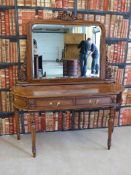 A maghogany bevelled mirror backed and crossbanded dressing table with carved details,