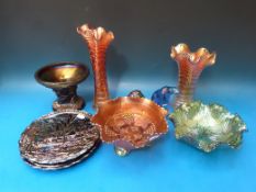 A collection of Carnival glass to include a pair of three handled swan vases, animals,