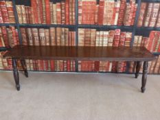 An oak bench raised on four turned legs