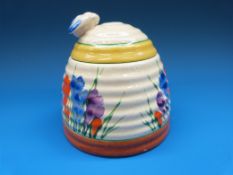 A Clarice Cliff honey pot with bee finial to the lid,