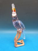 A Swarovski crystal red cockatoo on wooden perch in original box (25cm high)