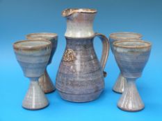 A Malcolm Cooke studio pottery jug and four goblet set