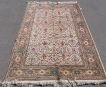 A wool rug with floral design on beige ground.