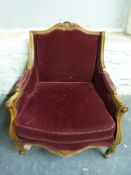 A carved Italian style armchair