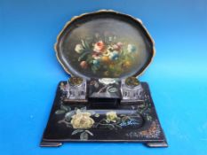 A lacquer desk stand with hand-painted floral and butterfly decoration and two glass ink wells,