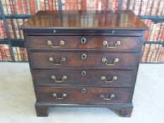 A Georgian mahogany bachelor's chest of four graduated drawers with brush slide raised on bracket