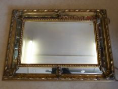 A 19thC gilt framed mirror with bevelled edge and starbursts cut into the side panels (overall size