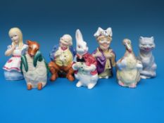 A set of seven Royal Worcester candle snuffers from The Alice in Wonderland Series