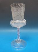 A 19thC Bohemian clear glass goblet etched to the body with hunting scenes among scrolling